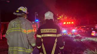 German firefighter Sven stand next to a Battlion Chief at the scene of an emergency