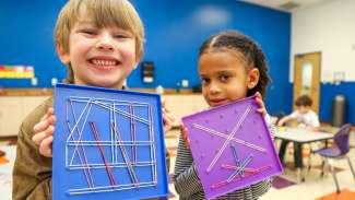 children smiling playing with learning tools