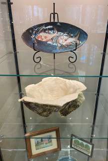 Artwork by Sunila Pendharkar on display in a glass display case ç