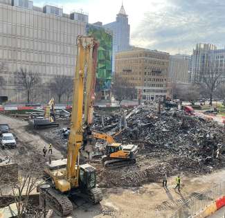 Large pile of rubble outside RMB looking toward the tree mural on the building off McDowell Street  