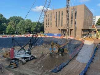 Image shows the civic tower construction site with crane with drilling rig. 