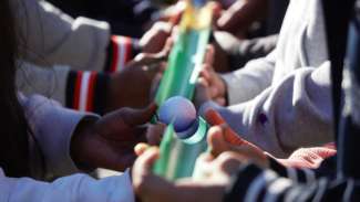 teens connecting a golf ball using tubes for teambuilding