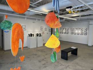 brightly colored hanging artworks in a gallery