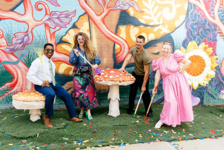 People having a party in front of a mural