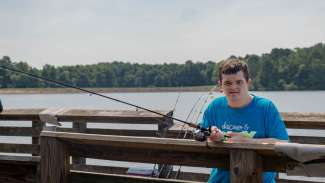 a camper on the bridge with fishing reel 