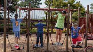 an image of campers playing on structure with an intern